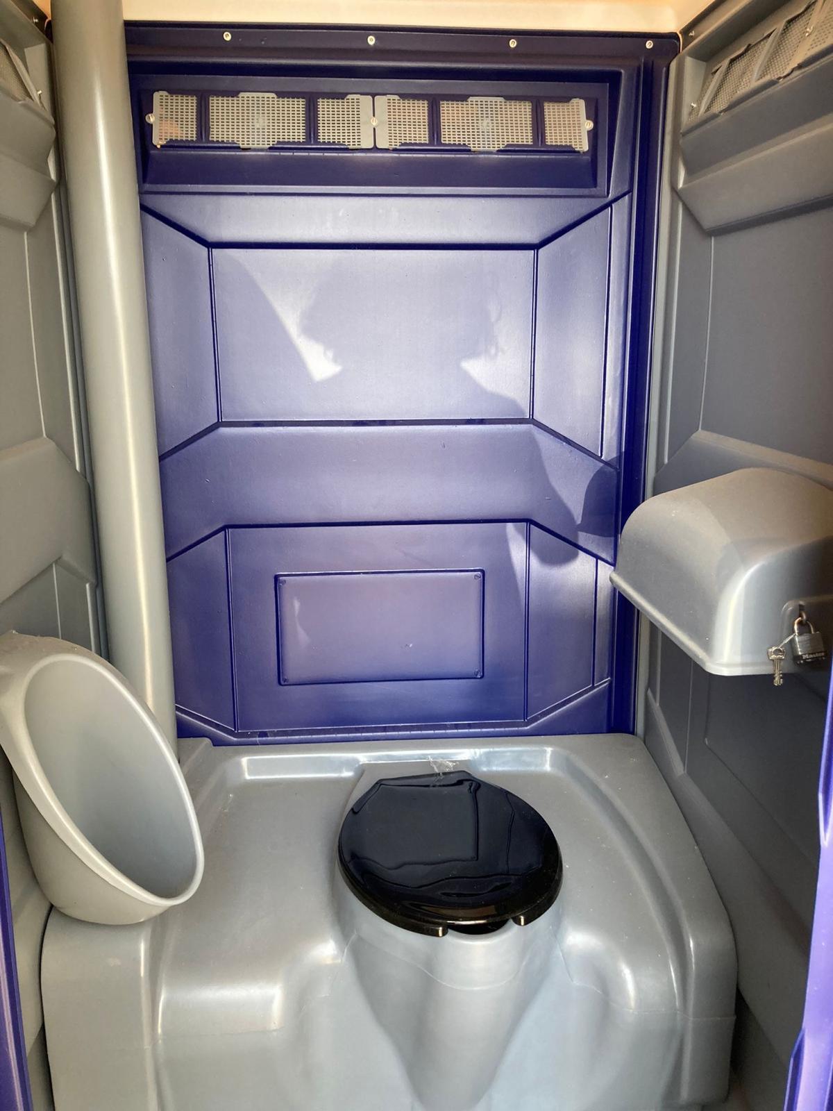 Clean portable restroom interior with urinal and toilet – Chicago rental
