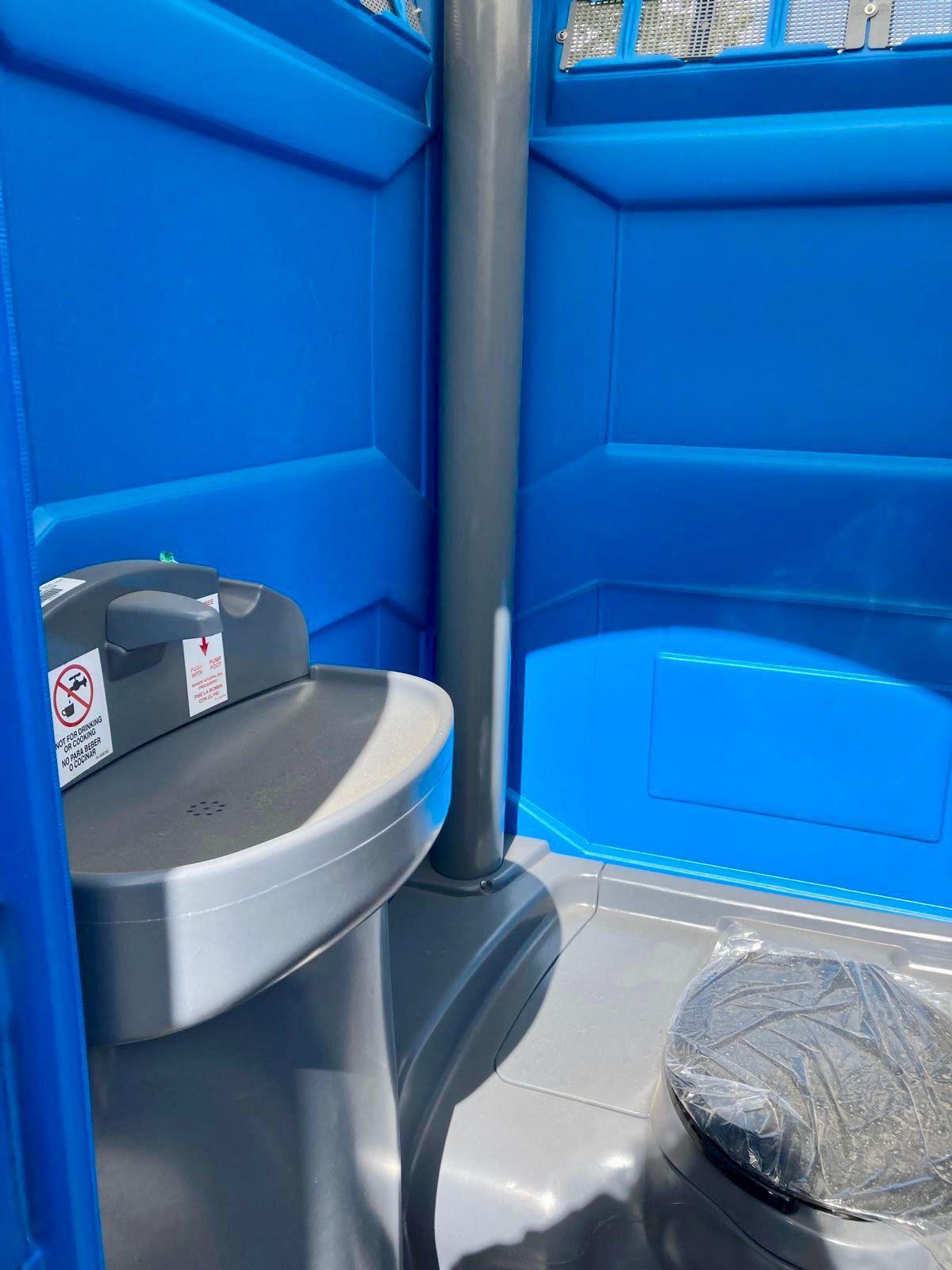 Premium portable restroom rental interior with built-in handwashing sink – Chicago, IL